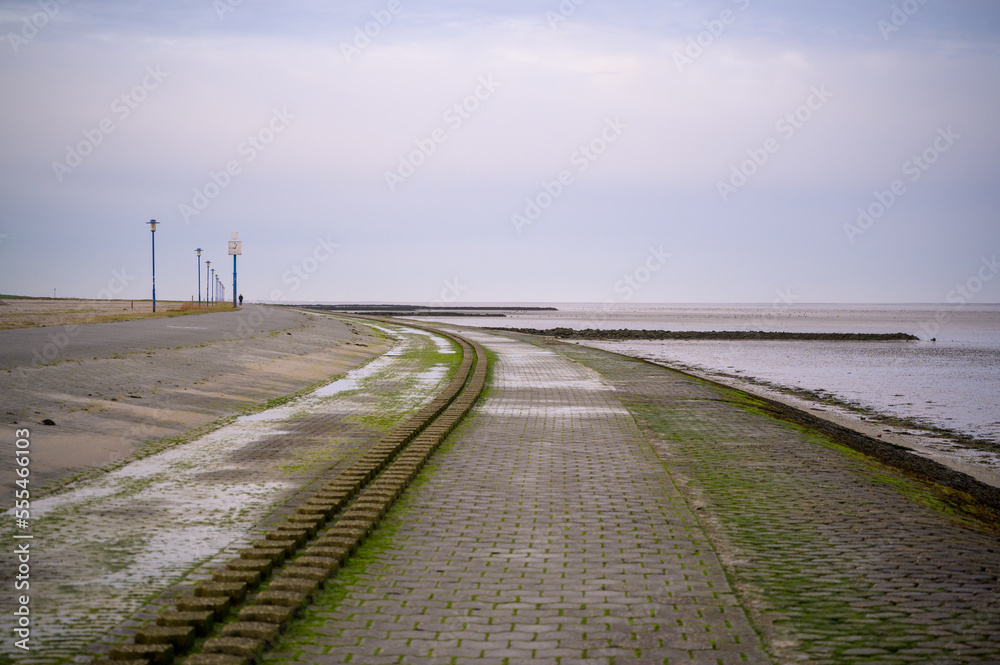 Beach promenade in Neuharlingersiel, Germany at low tide