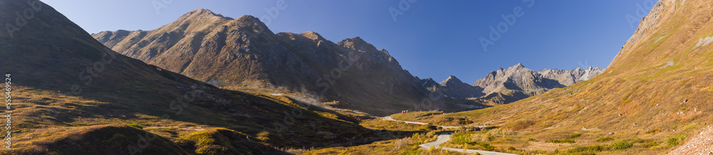 The road up to the Hatcher Pass Lodge and Gold Mint Mine is lined with autumn coloured tundra, Hatcher Pass, South-central Alaska; Palmer, Alaska, United States of America The road up to the Hatcher Pass Lodge and Gold Mint Mine is lined with autumn coloured tundra, Hatcher Pass, South-central Alaska; Palmer, Alaska, United States of America