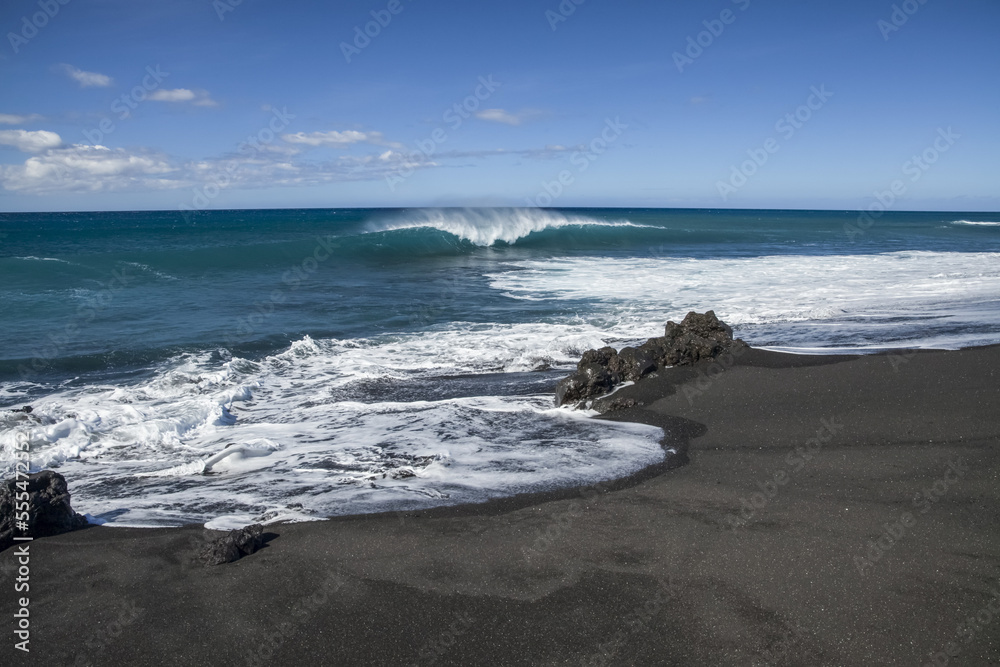 Surf breaking on the black sand beach, Pueo Bay, North Kona coast; Kailua-Kona, Island of Hawaii, Hawaii, United States of America Surf breaking on the black sand beach, Pueo Bay, North Kona coast; Kailua-Kona, Island of Hawaii, Hawaii, United States of America
