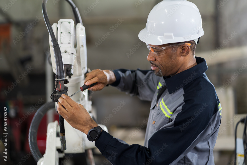 Male engineer worker using screwdriver maintenance automatic welding