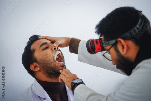 Fotografie South asian medical student practicing ent examination on each other wearing whi