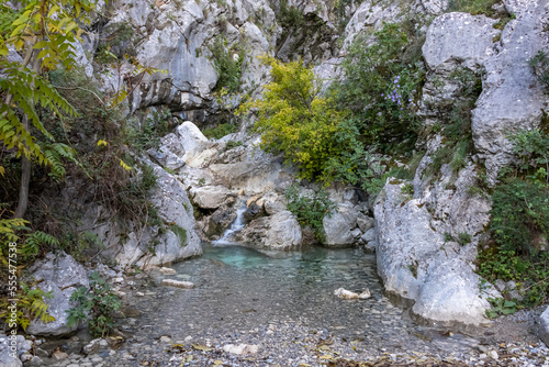 Hidden natural pool at the beginning of the ladder of Kotor hike, Montenegro, Balkan Peninsula, Europe. Small waterfall from the Scurda river. Lovcen, Orjen mountain range, Dinaric Alps photo