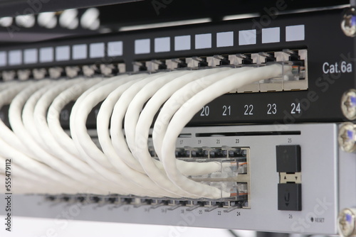 Connecting an Ethernet switch using patch cords with RJ45 connectors for data transmission in the data center.