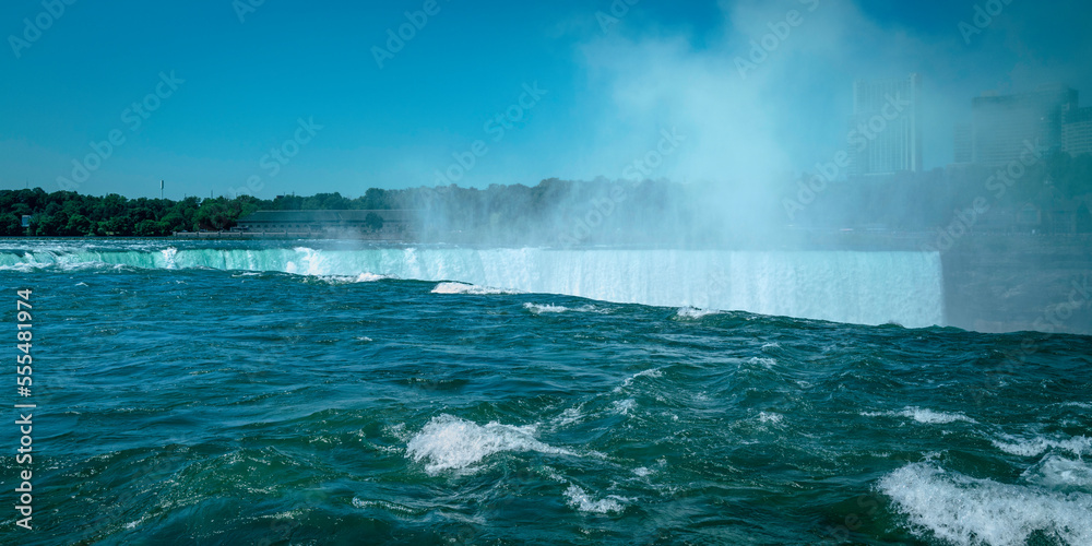 Niagara Falls Summer Travel Landscape Series, view of Canadian Side Skyline and river flowing down Horseshoe Falls in New York, USA