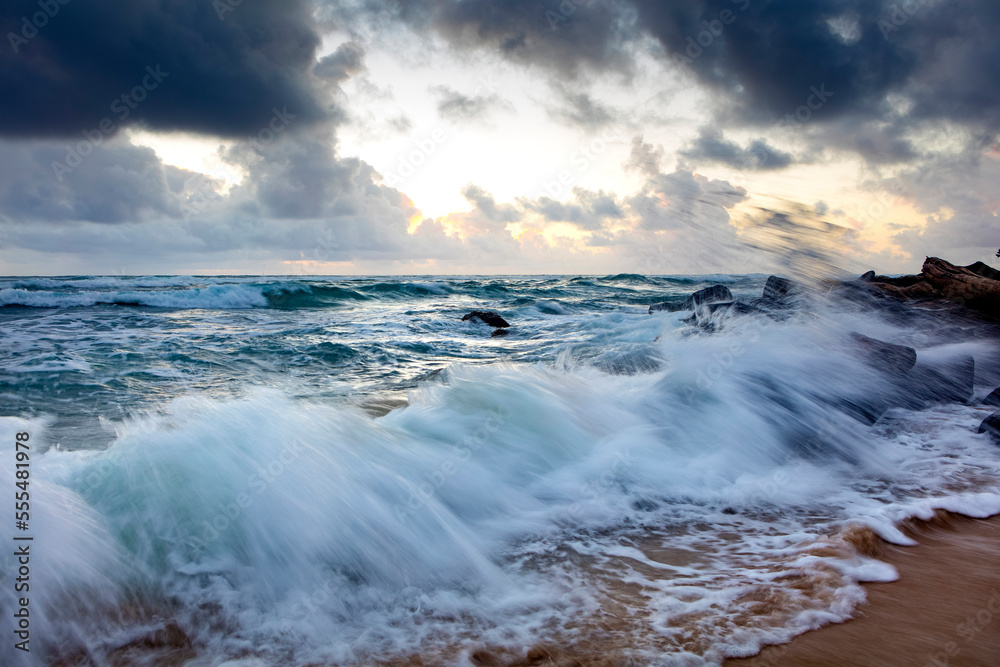 Sunrise through the clouds over the Pacific ocean, viewed from Lydgate beach; Kapaa, Kauai, Hawaii, United States of America Sunrise through the clouds over the Pacific ocean, viewed from Lydgate beach; Kapaa, Kauai, Hawaii, United States of America