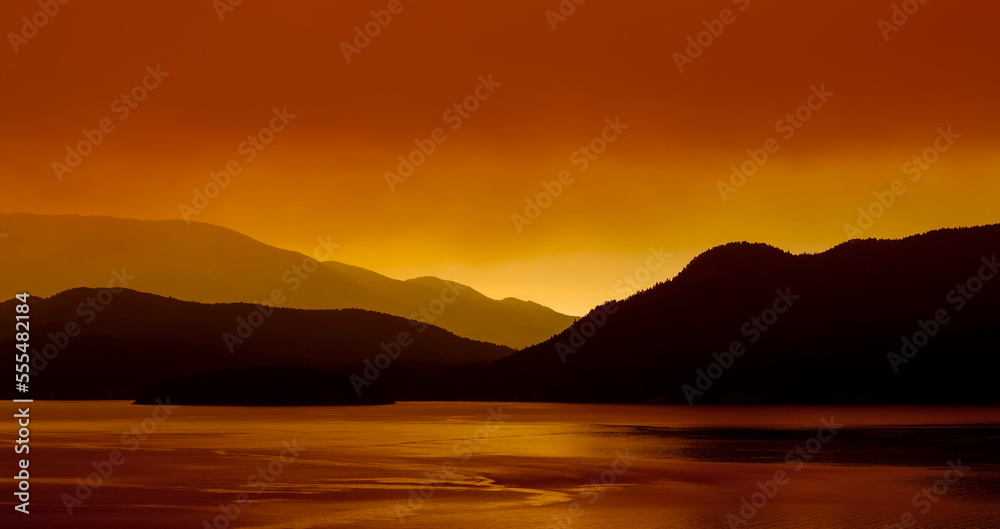 Gibsons Landing and the sky glowing red with forest fire smoke at sunrise, Sunshine Coast; British Columbia, Canada Gibsons Landing and the sky glowing red with forest fire smoke at sunrise, Sunshine Coast; British Columbia, Canada