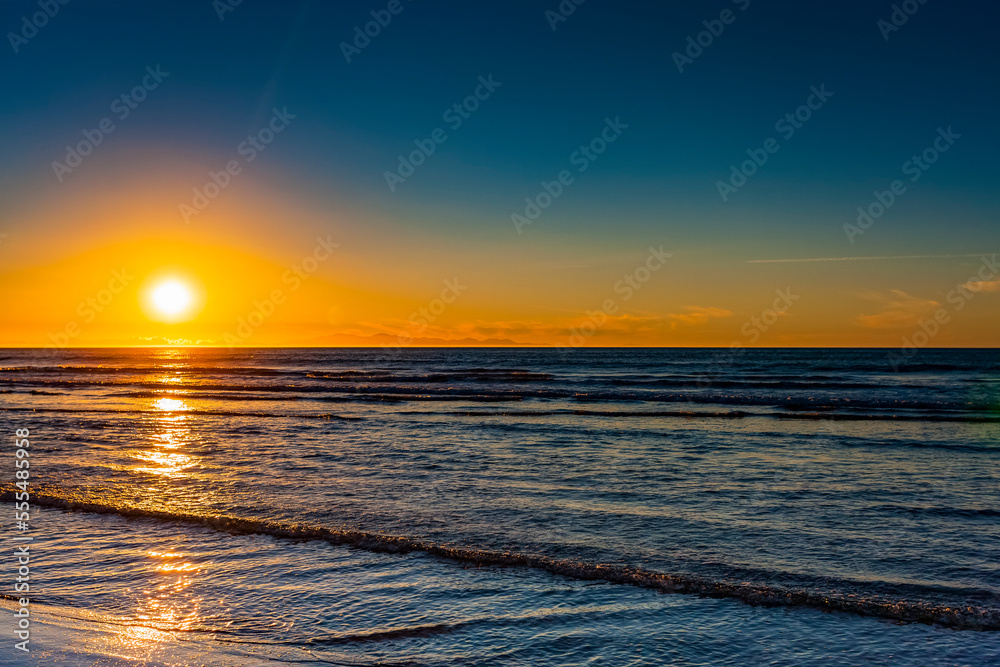 Golden sunset over the Pacific ocean, viewed from the North shore; New Zealand Golden sunset over the Pacific ocean, viewed from the North shore; New Zealand