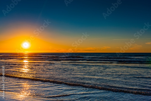 Golden sunset over the Pacific ocean, viewed from the North shore; New Zealand