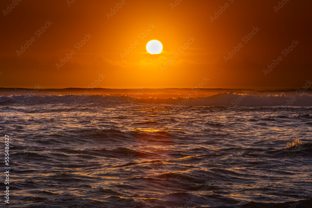 Bright golden sunrise over the Pacific Ocean; Kauai, Hawaii, United States of America Bright golden sunrise over the Pacific Ocean; Kauai, Hawaii, United States of America