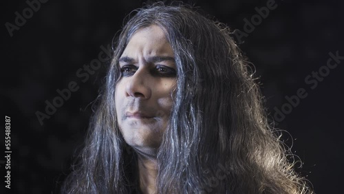 Pessimistic person.
The pessimistic man looks. Black background.
