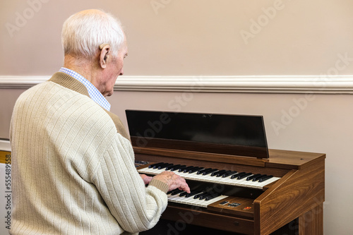 97 year old man playing the electric organ; Hartlepool, County Durham, England photo