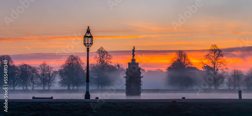 Bushey Park on a misty morning during a dramatic sunrise; London, England photo