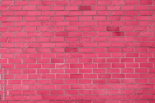 The texture of a brick wall in the trending color of 2023 viva magenta