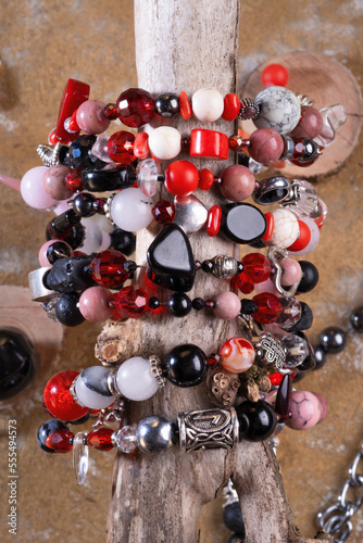 different   bracelets with black and red  semipreciouse stones with natural lava, shungite,  hematite,  rhodonite, coral  and others.  top view photo