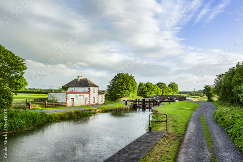 Old red and white house beside a lock on the grand canal in Kildare on a summer evening; Rathangan, County Kildare, Ireland photo