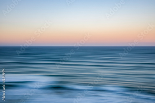 Panning sunrise over ocean, viewed from The Twelve Apostles, Port Campbell National Park; Port Campbell, Victoria, Australia