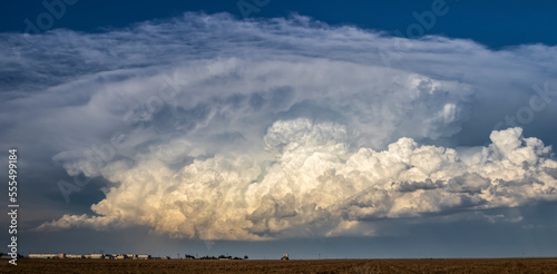 Robust updrafts begin to glow as the sun begins to set on an impressive line of increasingly severe thunderstorms; Burlington, Colorado, United States of America photo