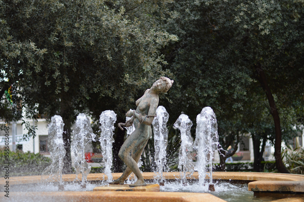 Fountain spout in the park with figure