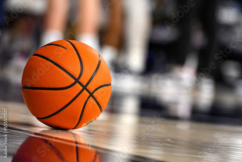 Close-up Basketball on Hardwood Court Floor in Basketball Arena © Myk Crawford