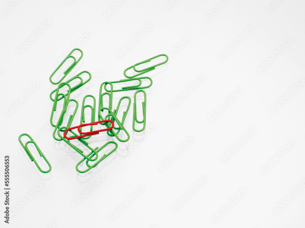 Green and red paper clips on white background, studio shot Green and red paper clips on white background, studio shot