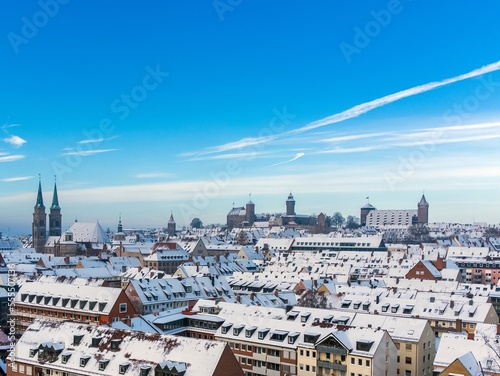 Winter panorama view over the blurred roofs of Nuremberg old town, with bright blue sky in the background.  photo