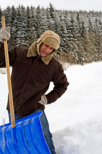 Man Shovelling Snow, Hof bei Salzburg, Austria photo