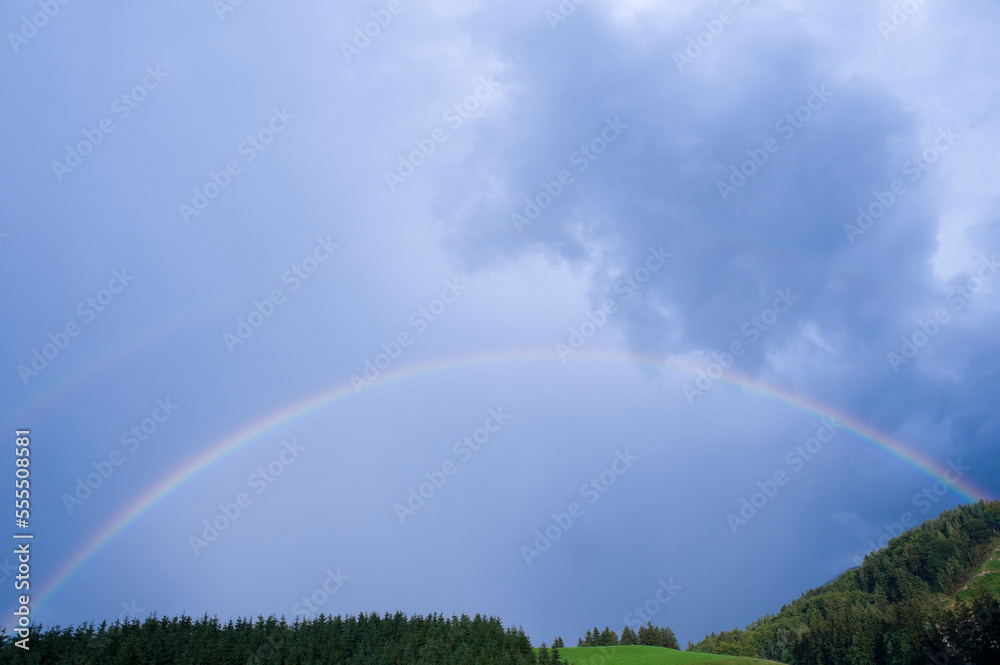 Rainbow over Field and Trees, Salzburg, Austria Rainbow over Field and Trees, Salzburg, Austria
