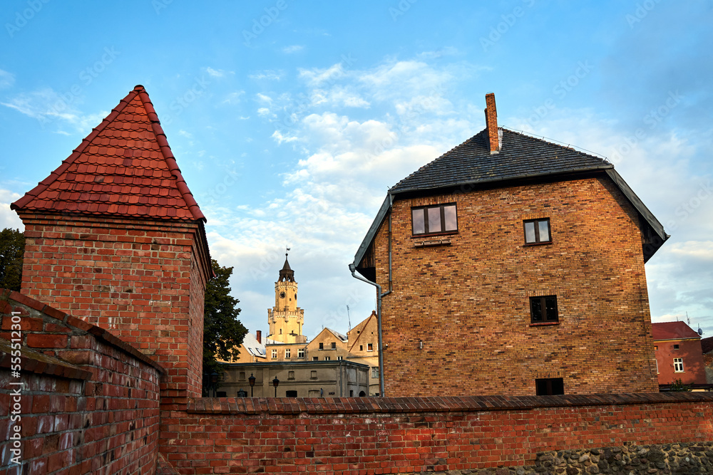 Medieval defensive walls, historic tenement houses and the tower of the town hall in the city of Wschowa Medieval defensive walls, historic tenement houses and the tower of the town hall in the city of Wschowa