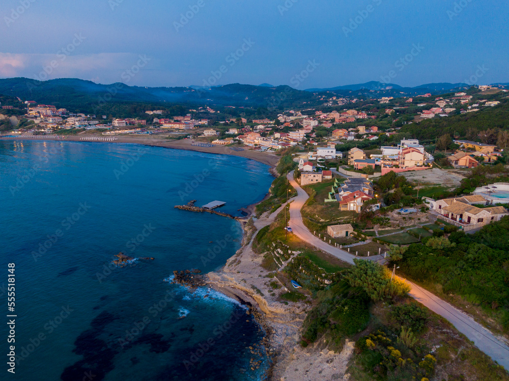 Aerial drone view of Agios Stefanos beach, a small tourist resort on the north east coast of Corfu in Greece 

