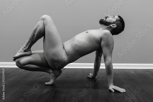 dynamic nude yoga pose by male fitness model, artist posing and modeling