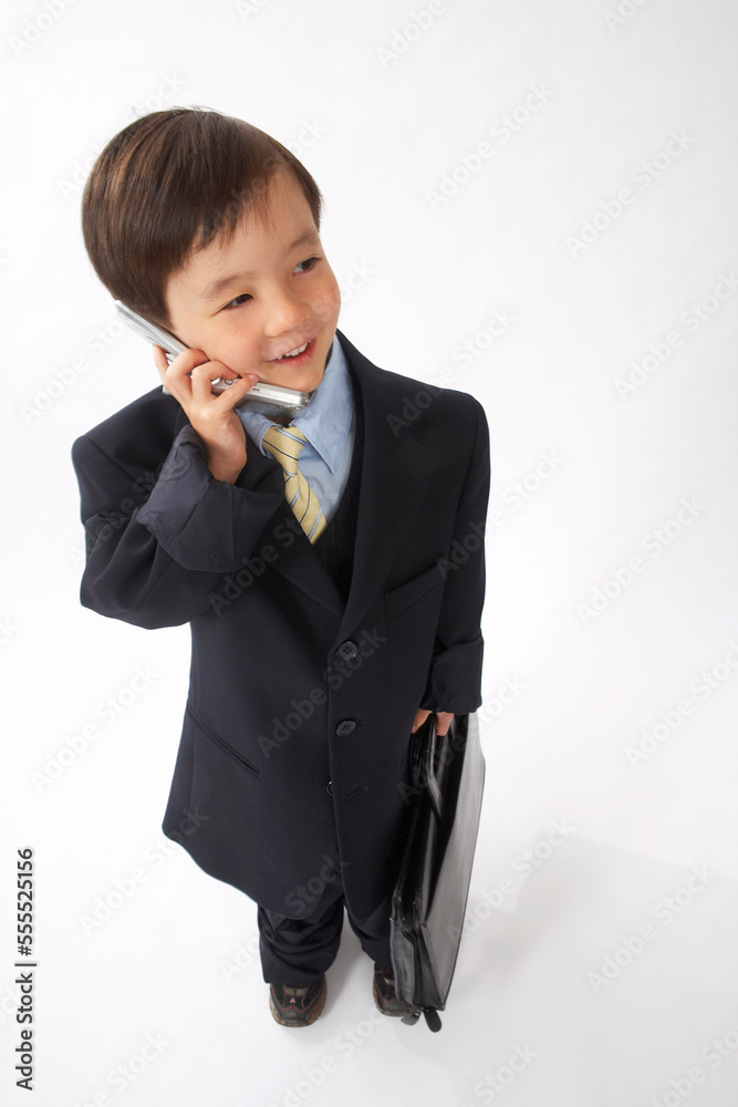 Little Boy Dressed Up as a Businessman Talking on Cell Phone Little Boy Dressed Up as a Businessman Talking on Cell Phone