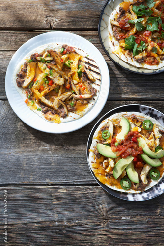Grilled Mini Pizzas with Chicken, Avocado, Cilantro, Refried Beans, Hot Peppers and Salsa photo