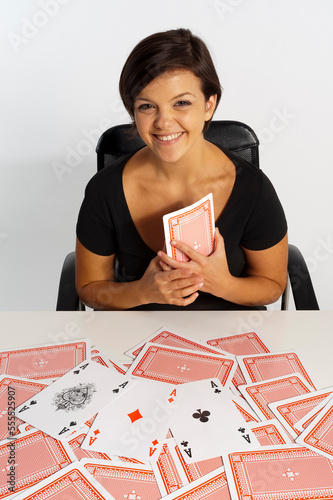 Mid-Adult Woman doing Magic Trick with Deck of Cards photo