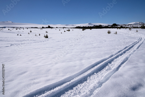 View of snowmobile tracks in the mountain snow field, in winter. © Gonzalo