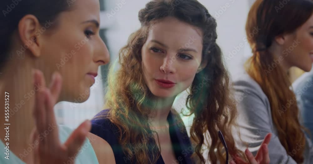 Animation of statistical data processing over two diverse female colleagues discussing at office Animation of statistical data processing over two diverse female colleagues discussing at office