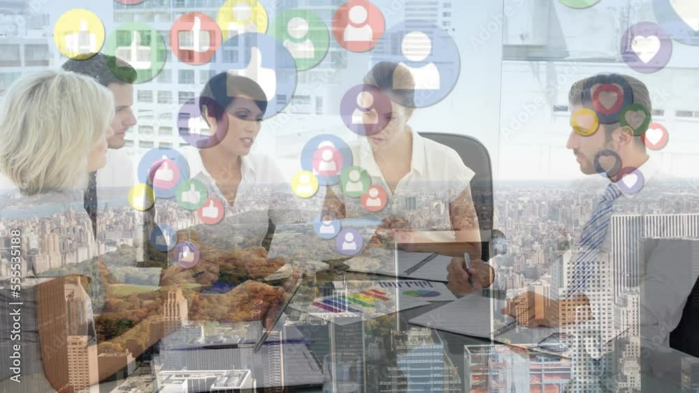 Animation of social media icons and cityscape over diverse business people in office Animation of social media icons and cityscape over diverse business people in office