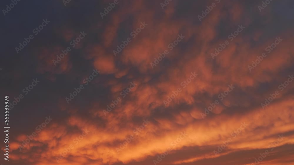 Majestic orange sunset or sunrise cloudscape. Dramatic sunset on dark cloudy sky Majestic orange sunset or sunrise cloudscape. Dramatic sunset on dark cloudy sky