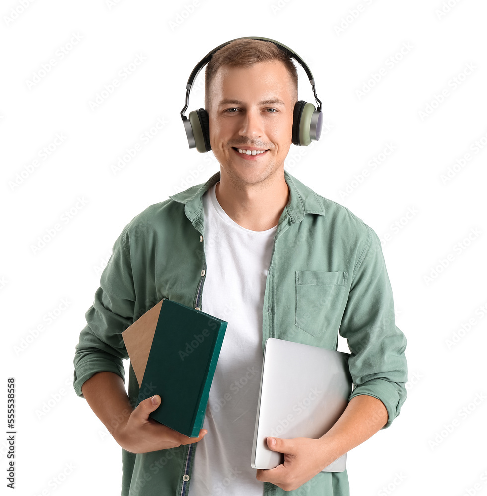 Young man with headphones, books and laptop on white background. Online education Young man with headphones, books and laptop on white background. Online education