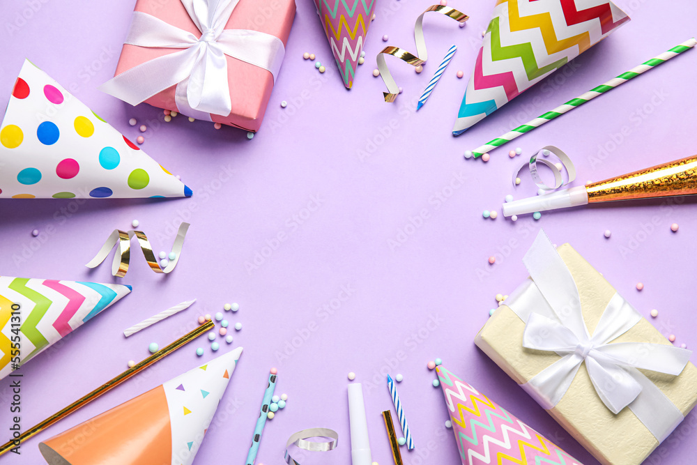Frame made of party hats, confetti and straws on violet background Frame made of party hats, confetti and straws on violet background