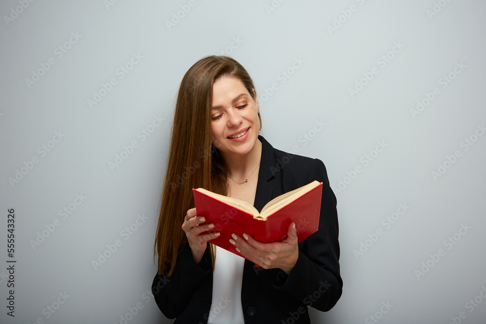 Smiling woman teacher or student holding open red book. Isolated portrait with copy space. Smiling woman teacher or student holding open red book. Isolated portrait with copy space.