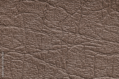 Brown artificial or synthetic leather background with neat texture and copy space