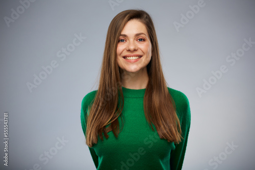 Smiling young woman in green. Isolated advertising portrait.
