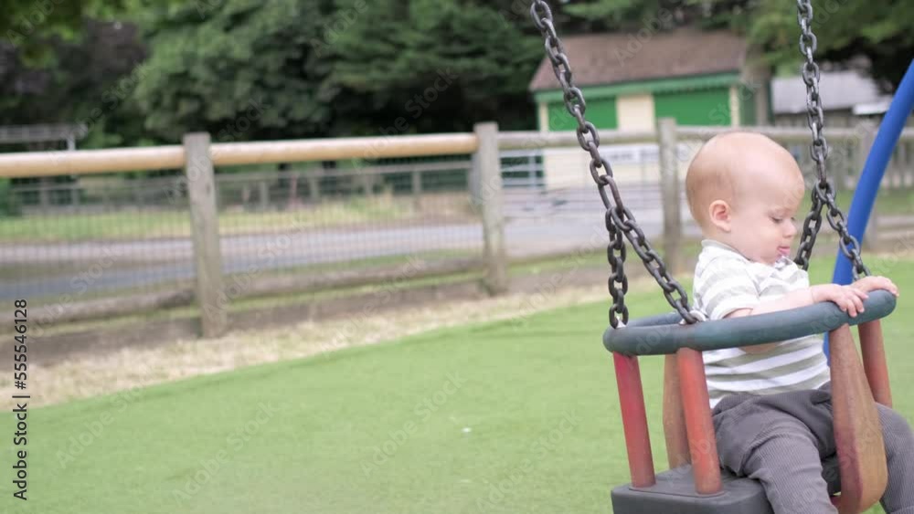 Funny Little Younger Newborn Infant Brother Boy On Swing. Baby Playing On Playground. Summer time outside. Kids Entertainment, Childhood, Child Development, Happy Family Concept Funny Little Younger Newborn Infant Brother Boy On Swing. Baby Playing On Playground. Summer time outside. Kids Entertainment, Childhood, Child Development, Happy Family Concept