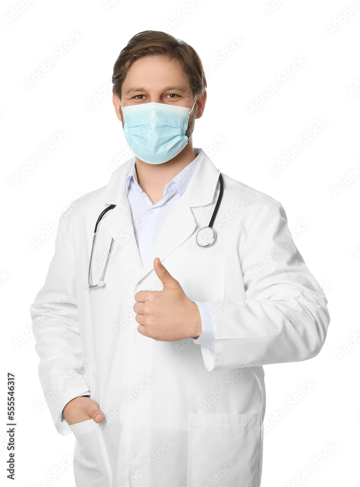 Doctor or medical assistant (male nurse) with protective mask and stethoscope showing thumb up on white background