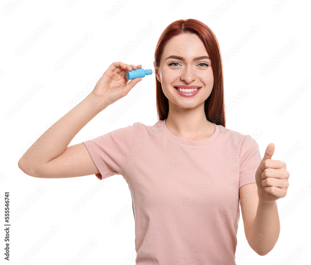 Woman using ear drops on white background Woman using ear drops on white background