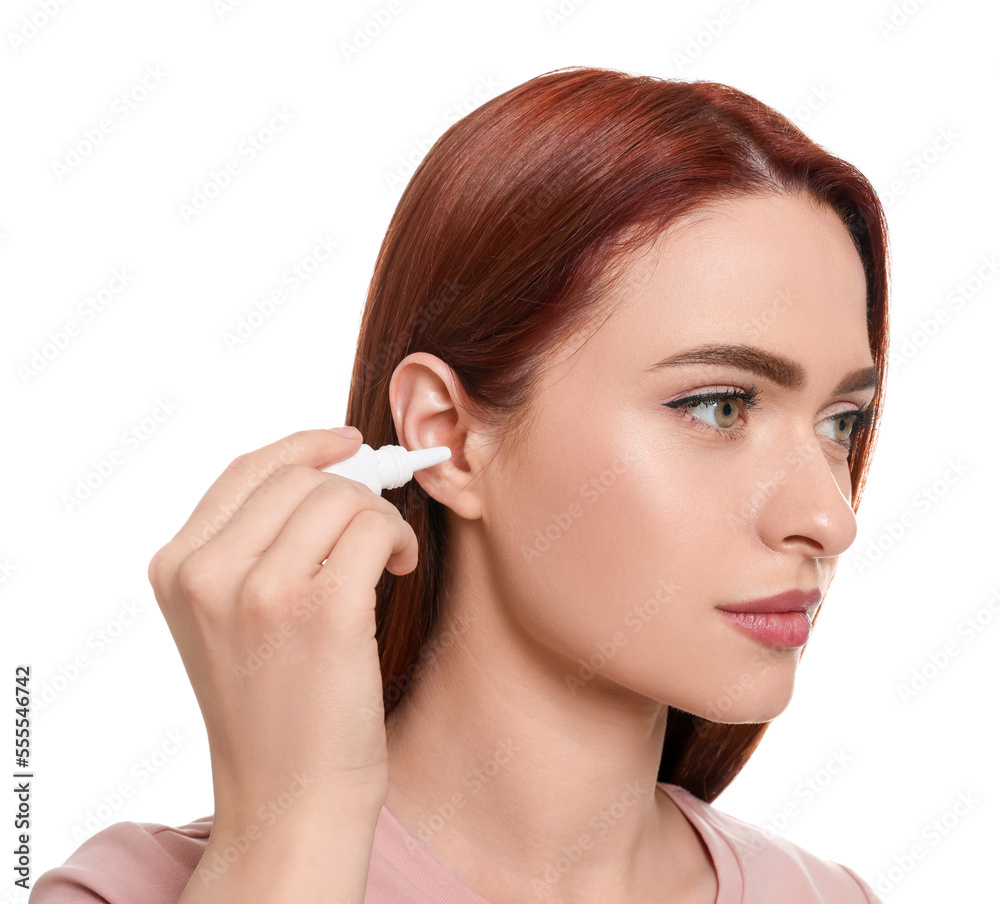 Woman using ear drops on white background