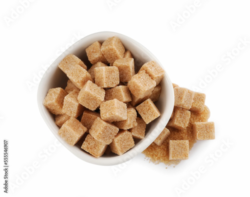 Bowl and brown sugar cubes on white background, top view