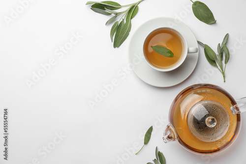 Aromatic herbal tea with sage on white table, flat lay. Space for text