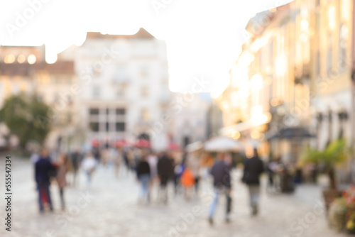 Fototapeta Naklejka Na Ścianę i Meble -  Blurred view of people walking on city street
