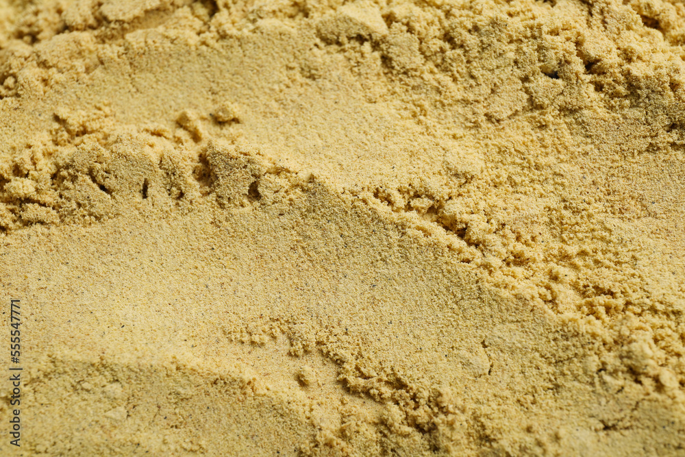 Aromatic mustard powder as background, top view Aromatic mustard powder as background, top view